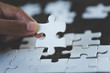 © Tinnakorn - Hand put the last piece of jigsaw puzzle to complete the mission, Business solutions, success and strategy concept