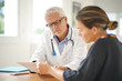 © goodluz - Doctor talking to patient in office