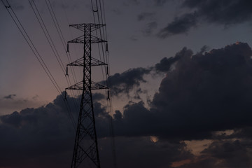 Power line on a background dark lights sky and city landscape.