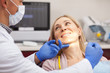 © Ihor - Cheerful mature woman smiling happily at her dentist during medical examination. Happy female patient enjoying painless teeth examination by professional dentist. Happiness, health, dentistry concept