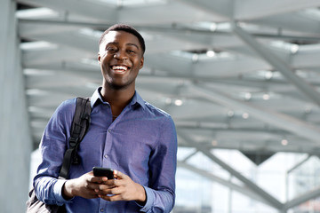 Wall Mural - african american young man with bag and cellphone