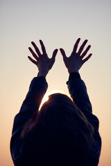 Wall Mural - Woman with arms wide open enjoying the sunrise / sunset time.