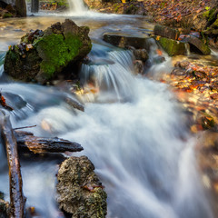 Stream flowing clean spring water. Photo taken in autumn in Russia.