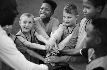 Sticker - Junior football team stacking hands before a match