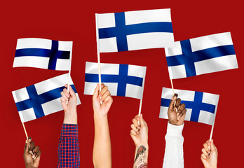 Wall Mural - Hands waving flags of Finland