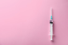Syringe With Liquid On Color Background