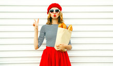 Portrait Pretty Cool Girl Wearing French Red Beret Holding Paper Bag With Long White Bread Baguette On White Wall Background