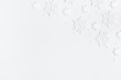 © Flaffy - Christmas composition. Christmas frame made of white snowflakes on pastel gray background. Winter concept. Flat lay, top view, copy space