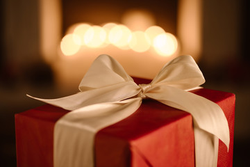 red present with white bow on blurred background