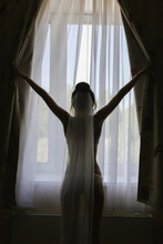 Silhouette Of A Beautiful Girl Bride Against The Window