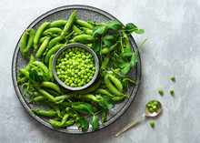 Green Peas On A Plate With A Bowl Of Shelled Peas.