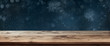 Wooden table with dark blue winter background