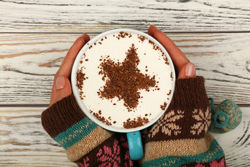 Wall Mural - Woman hands hold full latte cappuccino coffee cup