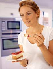 Canvas Print - WOMAN IN KITCHEN EATING CHEESECAKE