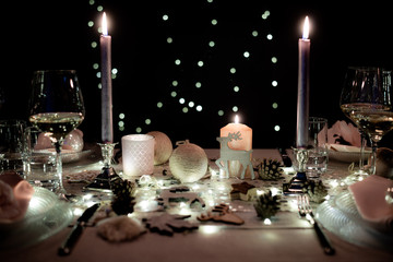 Wall Mural - christmas eve party table with wine glass and glitter season's greeting decoration