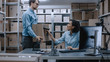 © Gorodenkoff - Female Inventory Manager Scans Cardboard Box and Digital Tablet with Barcode Scanner, Worker Holds Package. In the Background Rows of Cardboard Boxes with Products Ready For Shipment.
