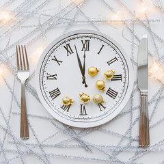 Wall Mural - Festive table setting with clock plate. Knife and fork.Christmas decorations. New Year. 