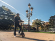 Modern Man with Helmet Using Electric Scooter in sunny Park 8
