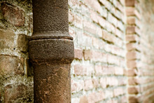 Detail Of A Downpipe Against A Brick Wall - (Tuscany - Italy)