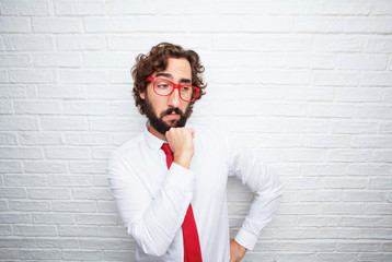 Poster - crazy businessman expressing a concept. brick wall background