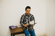 © ADDICTIVE STOCK - Young man holding magazine near table in room