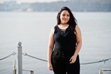 Pretty Latino Model Girl From Ecuador Wear On Black Posed Against Lake.