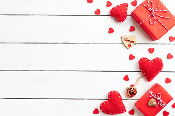 Valentines day background concept. Top view of Red gift box with handmade red heart on white wooden background.