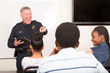 © Studio615 - Officer teaching community outreach class full of students