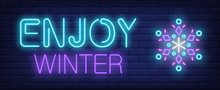 Enjoy Winter Neon Text With Snowflake. Christmas Advertisement Design. Night Bright Neon Sign, Colorful Billboard, Light Banner. Vector Illustration In Neon Style.