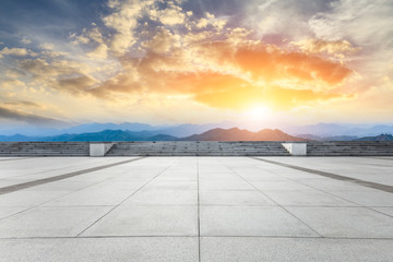 Empty floor and green mountain with beautiful clouds at sunset