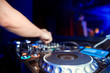 © Семен Саливанчук - Dj mixes the track in the nightclub at party. Headphones in foreground and DJ hands in motion