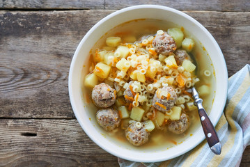 Wall Mural - Soup with meatballs, pasta anellini and vegetables in a bowl