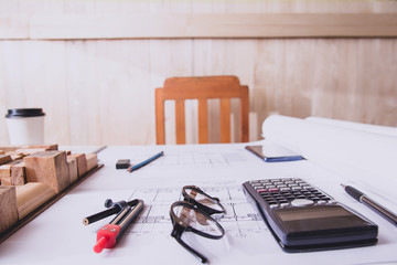 Concept architects, equipment architects On the desk with a blueprint in the office. Selective Focus