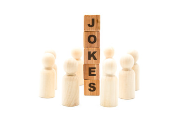 Wall Mural - Wooden figures as business team in circle around word JOKES