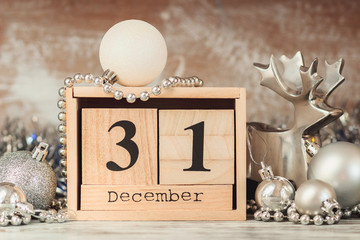 Wall Mural - Hand changing wooden calendar with different New Year decorations