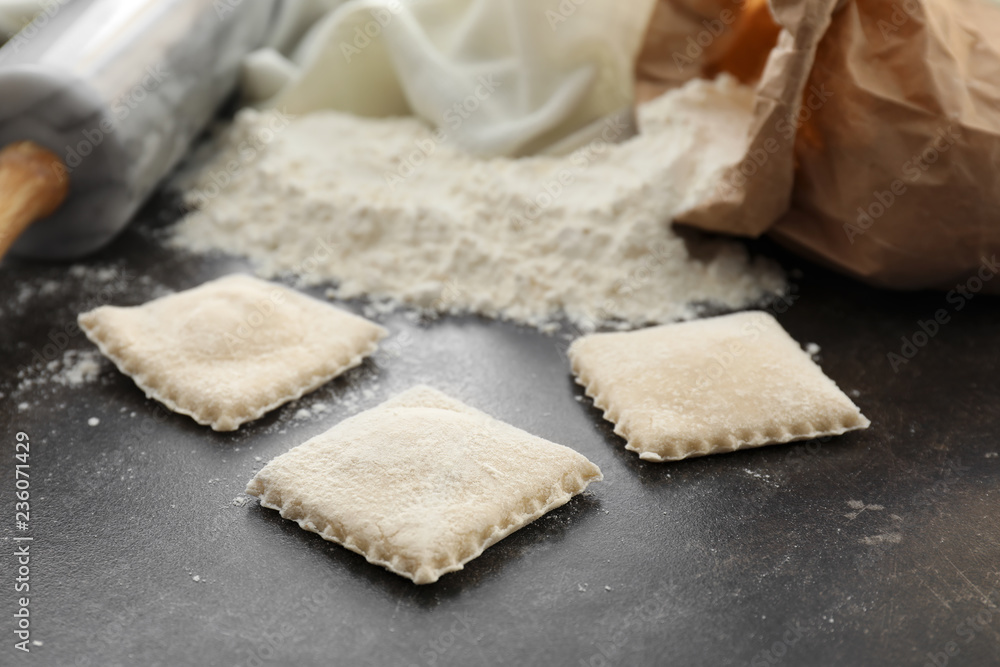 Tasty ravioli on table