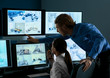 © Pixel-Shot - Security guards monitoring modern CCTV cameras in surveillance room