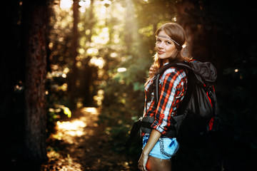 Wall Mural - beautiful and young woman hiking in forest
