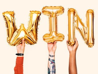 Canvas Print - Hands showing win balloons word