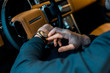 © LIGHTFIELD STUDIOS - cropped image of businessman checking watch in luxury car