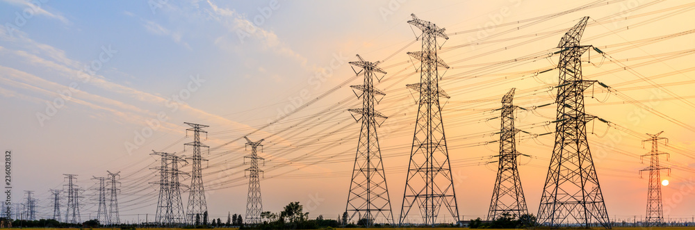 high-voltage power lines at sunset,high voltage electric transmission tower - obrazy, fototapety, plakaty 