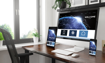 Canvas Print - black and white desktop with three devices showing landing page