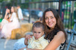 © jollier_ - Mom holds a child in her arms. A happy family. Young mother holding her baby in her arms and stroked my mother's child litso. Portret mother and little son.