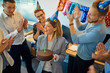 © Westend61 - Colleagues having a birthday celebration in office with cake and party hats