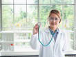 © potsawat - asian doctor is showing the stethoscope in the lab
