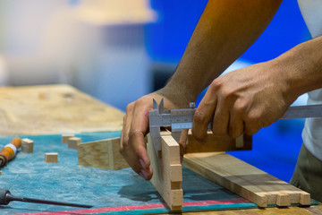 Carpenter working with timber in shop