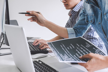 Programmers cooperating at Developing programming and website working in a software develop company office, writing codes and typing data code