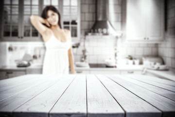 Wall Mural - slim young woman and white wooden table in kitchen 