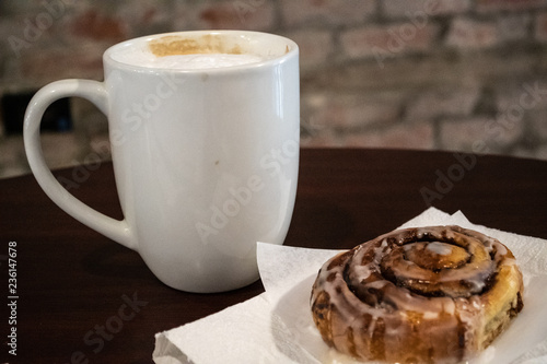 Good Morning Cappaccino In A White Coffee Mug Next To A Sweet Cinnamon Roll Swirls And Frosting Overhead Or Closeup Shots Stock Photo Adobe Stock Good Morning Cappaccino In A White Coffee Mug Next To A Sweet Cinnamon Roll Swirls And Frosting Overhead Or Closeup Shots Stock Photo Adobe Stock