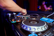 © Семен Саливанчук - Dj mixes the track in the nightclub at party. Headphones in foreground and DJ hands in motion